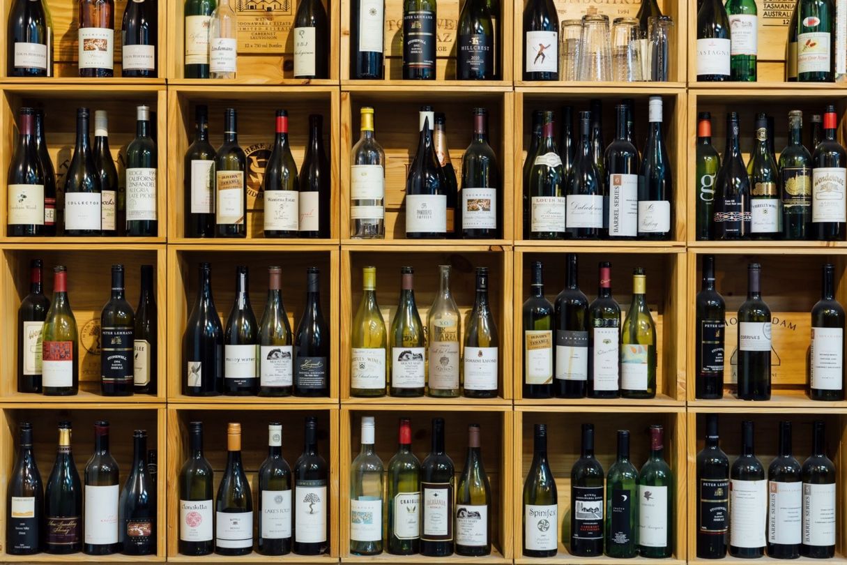 Extensive collection of premium Australian and international wines stored in wooden wine racks.