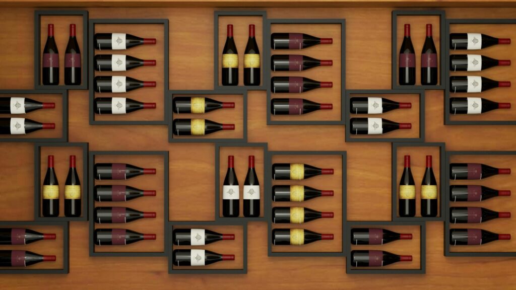 Overhead view of red wine bottles stored in modern wooden wine racks, showing a simple and organized layout for building a beginner wine collection.